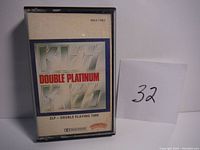 Front view of cassette tape case showing Kiss Double Platinum label and logo.