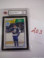 Front view of 1983-84 O-Pee-Chee #343 Rick Vaive hockey card in protective case showing player image and grading label.