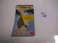 Front view of packaging showing Lucky Strike 1 inch Rudder Flash lure with swivel and hook attached. Price tag from seller visible.