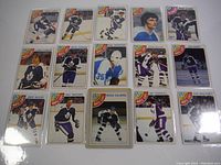 Photo showing 15 hockey trading cards laid out flat featuring various players from the Toronto Maple Leafs, including Borje Salming and Paul Harrison.