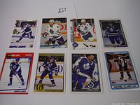 Full view of 8 Wendel Clark hockey cards arranged in two rows of four showing various designs and branding.