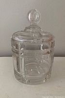 Full view of the glass candy jar with lid, showing geometric patterns and knob handle.