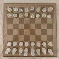 Full view of the chessboard showing all clear and frosted glass pieces arranged in starting chess positions.