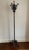 Full height view of the coat stand on hardwood floor showing overall design and proportions