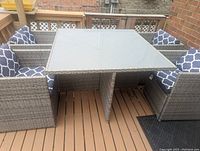 Angled view of complete assembled set including table and chairs on a deck