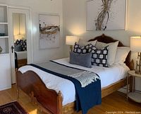 Bed frame assembled with linens and pillows (not included) for context