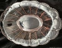 Top angle view of pink depression glass bowl showing diamond pattern and scalloped beaded edge.