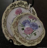 Two-piece Paragon set featuring a wide-mouth teacup and matching saucer, floral pink and blue design with gold trimming.