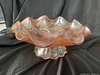 Side view showing the ruffled edges and the clear textured pedestal base.