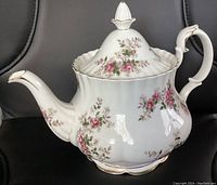 Full view of the Royal Albert Lavender Rose teapot showing the body, handle, and spout with floral patterns and gold trim.