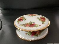 Side view of the Royal Albert Old Country Roses trinket dish with lid, showing the floral pattern and gold edging.