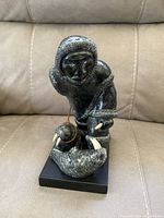 Front view of the soapstone Eskimo sculpture with walruses showing details of the figure and animals.