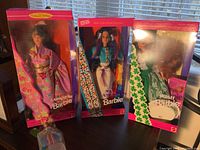 Four Barbies boxed and displayed: Japanese, Native American, Irish (opened), Bubble Angel. Boxes show special edition and cultural themes.