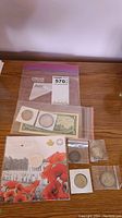 Full overview of the lot including coins in holders and bags and the one dollar bill