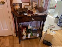 Front view showing stand with drawer and lower shelf