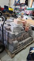 Full skid of stacked patio stones in garage environment