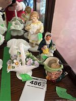 All three Royal Doulton pieces displayed together on shelf