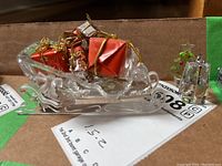 Clear cut crystal sleigh ornament with scroll-shaped runners