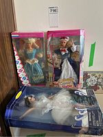 Three boxed Barbies: Dutch Barbie, Colonial Barbie, and Swan Queen Barbie packaged and displayed upright
