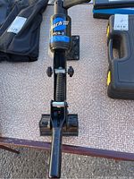 Close-up photo of the top view of Park Tool PCS-2 black metal bike frame holder clamp with spring-loaded mechanism and adjustment knobs.