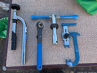 Top-down view of five Park Tool bike repair tools laid out on table.