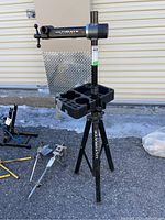 Full view of bike workstand showing tripod base, center post, tool tray and clamp arm