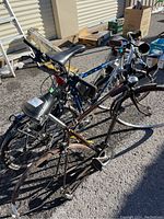 Three bicycles parked close together showing different styles and visible wear.