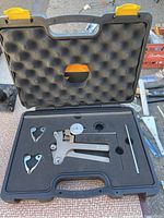 Open black carrying case with Pillar Racing spoke tension meter and accessories nestled in foam.