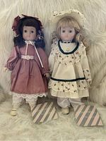 Two vintage Enchantment dolls with stands, brunette in pink dress and blonde in cream and aqua dress