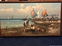 Full view of the large fishing scene oil painting with boats and fishermen along the shore, with hand carved wooden frame.