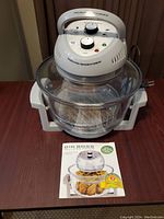 Full view of the Big Boss Halogen Air Cooker with glass bowl, metal rack inside, and control unit on top