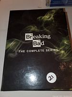 Front cover of Breaking Bad complete series DVD set with logo and smoke design.