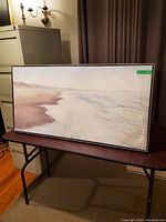 Full view of the canvas art showing a soft beach scene on a table.