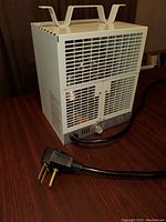 Compact metal heavy duty heater with front grills, top handles, adjustable knob and power cord