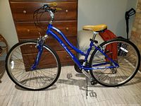 Side view showing frame, wheels, handlebar, saddle and pedals