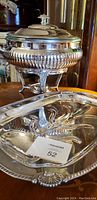 Photo showing antique silver plated warmer with lid and part of Sheffield silver turkey tray