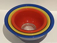 Nested view of all three mixing bowls showing varying sizes and clear glass bottoms.