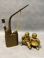 Antique AC Williams cast iron Campbell's Soup Kids coin bank with old Chinese copper smoking pipe and two small child figurines