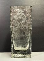 Front view on dark background showing full acid-etched female figure.