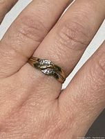 Close-up of the vintage 8K gold ring worn on finger showing the linked design and textured gold detail.