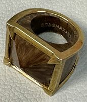 Close-up image of a vintage gold-tone BCBG MAXAZRIA ring with angular open design from The Vestiaire Collection