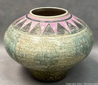 Front view of vintage raku pottery seed pot with signature, showing crackled glaze and pink triangular designs near opening.