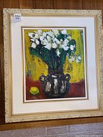 Front view of the framed original oil painting featuring white flowers in a dark vase on yellow and brown background.