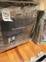 Main packaged queen size duvet cover with GlucksteinHome branding visible on packaging showing European Down Duvet Cover interior in taupe neutral shades.