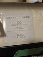 Package label of double bedskirt showing brand Distinctly Home, 400 thread count, 100% Egyptian cotton, in white.