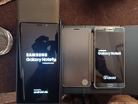 Front view of Samsung Galaxy Note9 and Note5 powered on in open folio cases