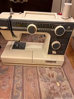 Front view of Janome sewing machine with thread spool on top