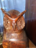 Front view showing detailed carved facial features and polished wood texture.