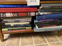 Books stacked on lower shelf showing titles related to travel, Canadian history, and photographic collections.
