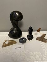Overall view of six decorative carved items on table with lot number card